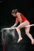 Gymnast preparing high bar with sandpaper
