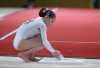 Gymnast chalking up before her floor exercise